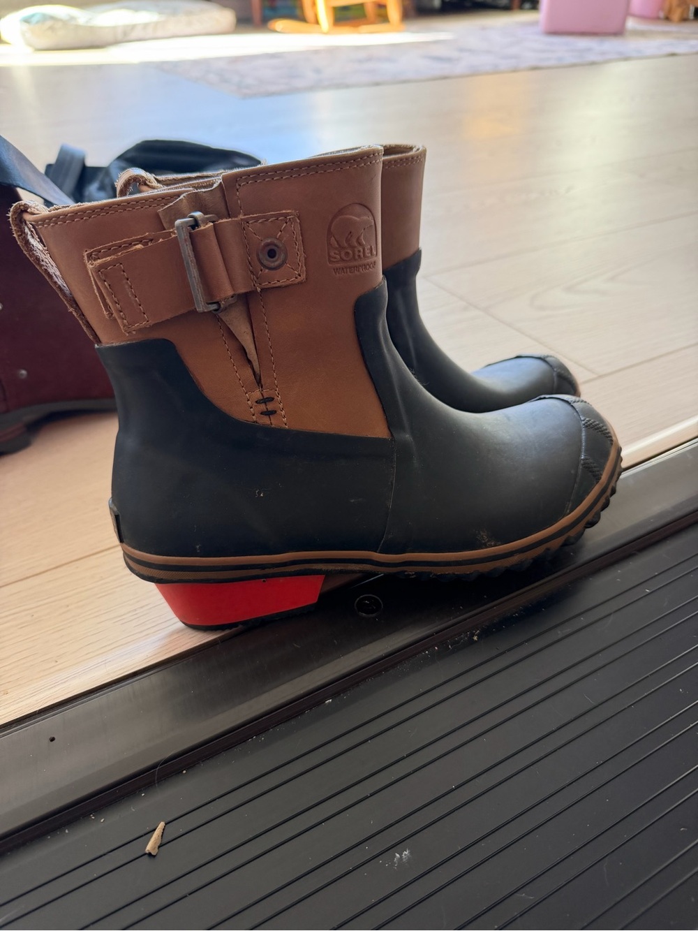 Sorel Black and Brown Waterproof Winter Boots with Red Heel Accent